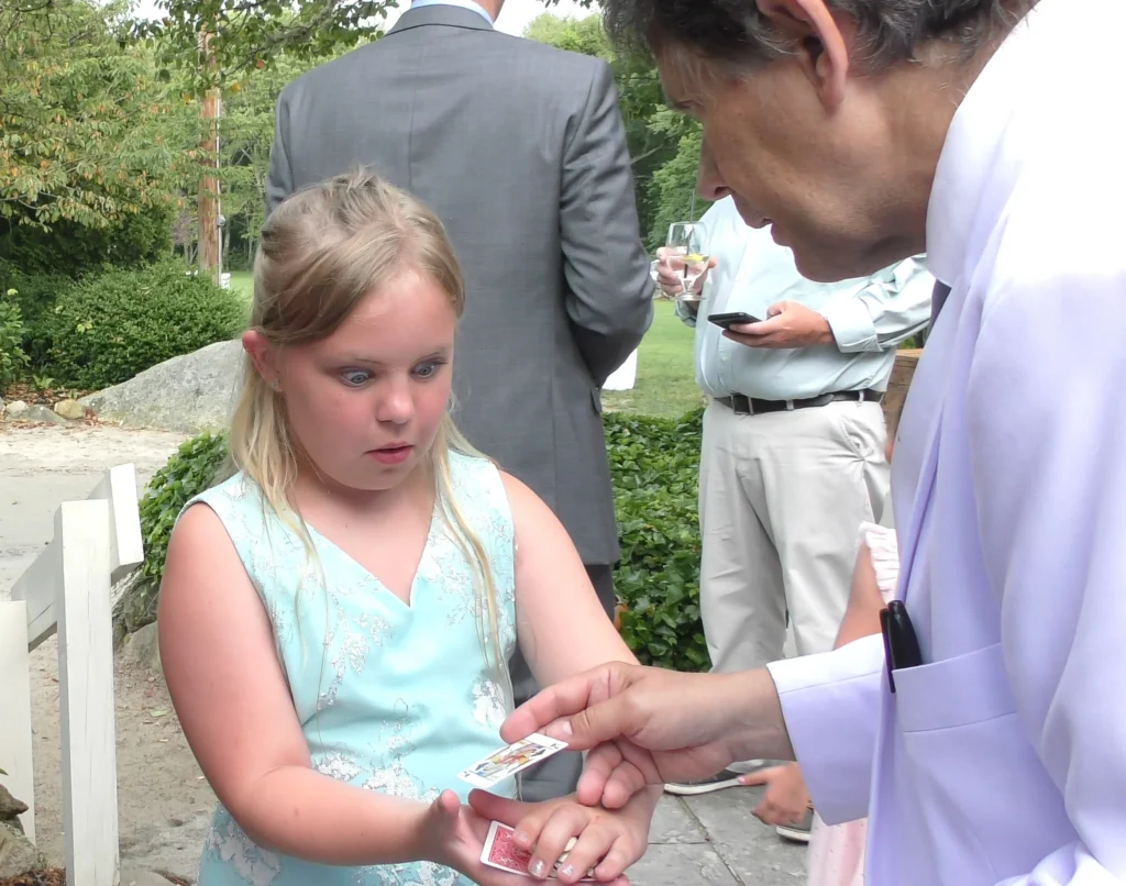 A very surprised expression in a young girl's face, seeing "Magic" of Boston Magician.