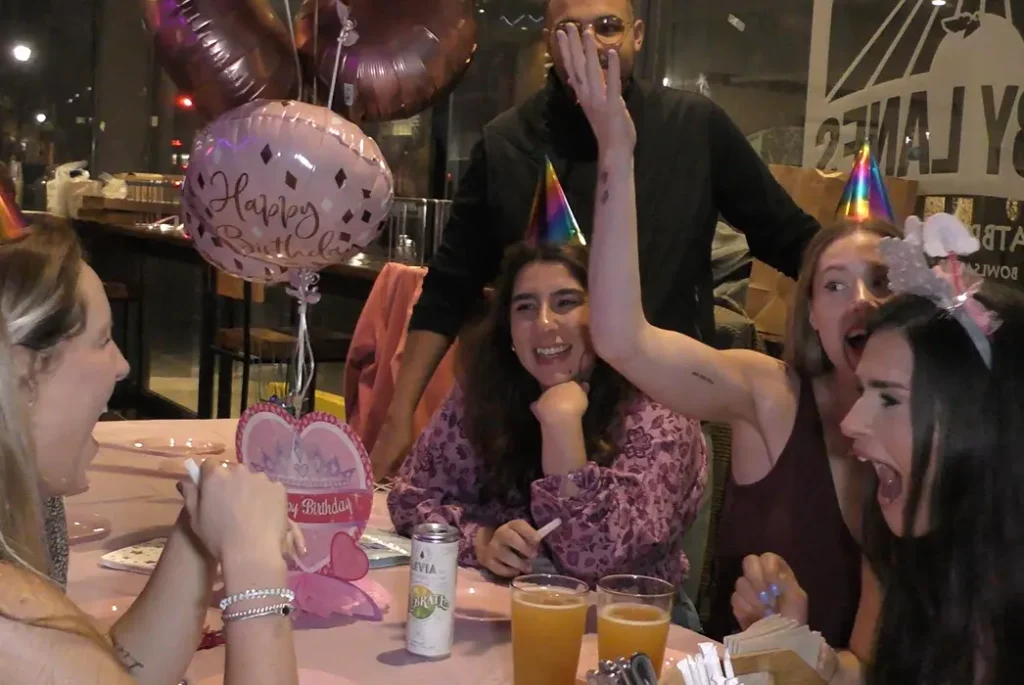 Adult Birthday Magician Boston Massachusetts The Best in Magic Entertainment Image of adults celebrating a friends birthday with baloons and party hats and enjoying the magic entertainment of Boston Massachusetts Magician Joe Ferranti